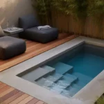 Modern rectangular plunge pool in a small backyard with wooden decking