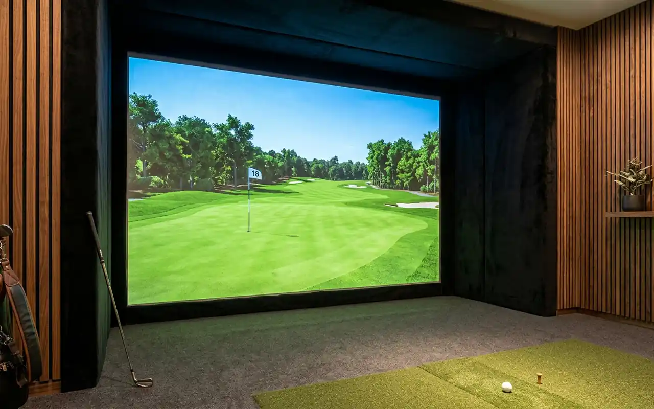 A close-up of a high-definition impact screen framed with black velvet and soft walnut wall panels.