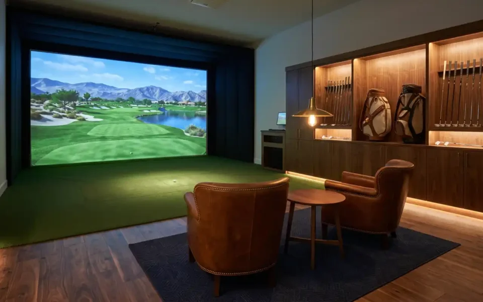 A luxurious golf simulator man cave with a large impact screen, premium turf, and a leather lounge area.