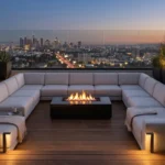 A modern roof terrace with modular grey seating, glass railings, and a city view.