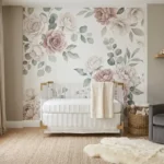A luxurious nursery room with an acrylic crib, warm greige walls, and a large floral mural.