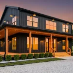 A modern matte black barndominium with large glass windows and light wood accents.