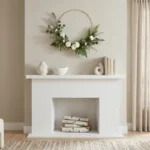 A modern living room featuring a minimalist gold hoop wreath hanging over a fireplace mantle.