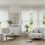 A luxurious modern sunroom with floor-to-ceiling glass, rattan furniture, and lush green plants.