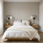 Minimalist tiny guest bedroom with warm greige walls and white bedding.