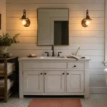 Cozy farmhouse bathroom with distressed white shaker vanity, oil-rubbed bronze faucet, and horizontal shiplap accent wall