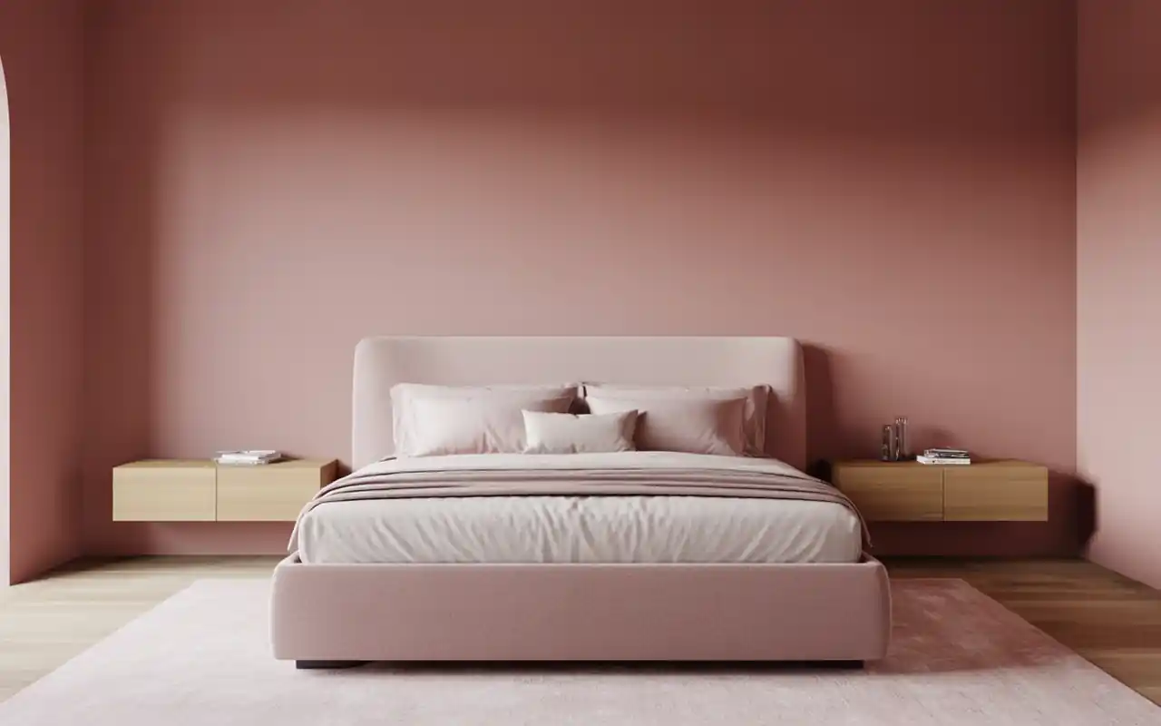 Functional pink bedroom layout showing a sleek upholstered bed frame and clean floating nightstands.