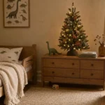 Dinosaur-themed kids Christmas tree with matte green and terracotta ornaments, amber LED lights, and dino topper on a child's bedroom dresser