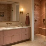 Sophisticated adult pink bathroom with dusty rose zellige tile walls, brushed brass fixtures, and walnut floating vanity
