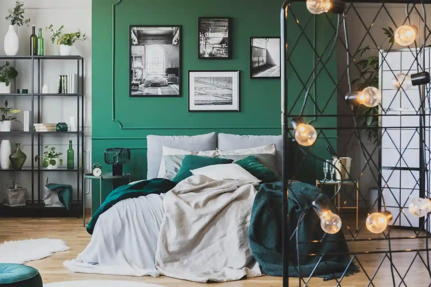 Layered bedroom with upholstered headboard, warm bedside lamps, framed art, and a rug floating past the bed