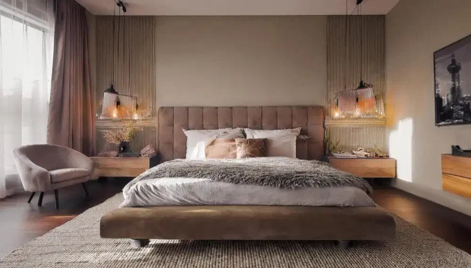 Calm, styled bedroom with warm greige walls, layered linen bedding, and warm 2700K bedside lamp