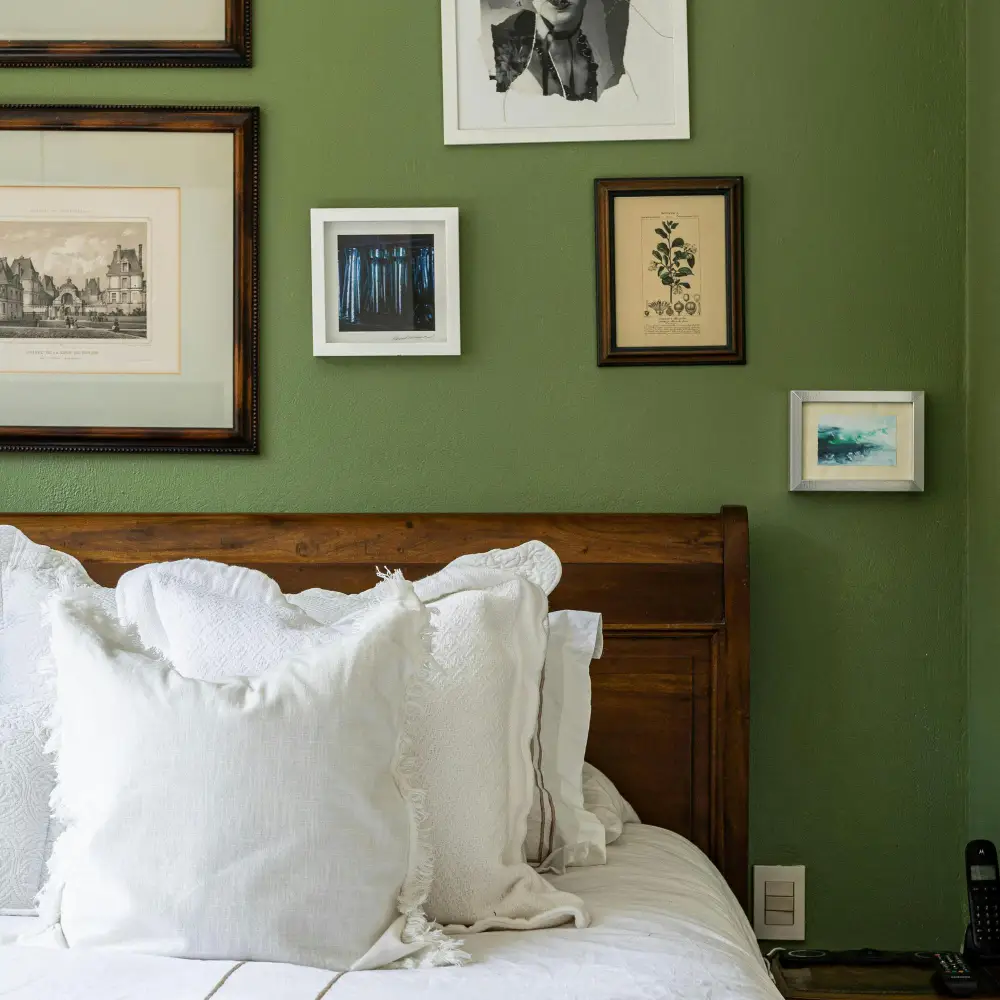Dark academia dorm bedding with hunter green velvet duvet, white cotton sheets, and a dark plaid wool throw
