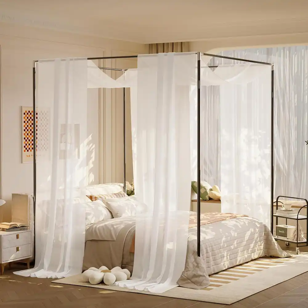 Floor-length oat linen curtains hung high above the window in a warm master bedroom, hems brushing the floor