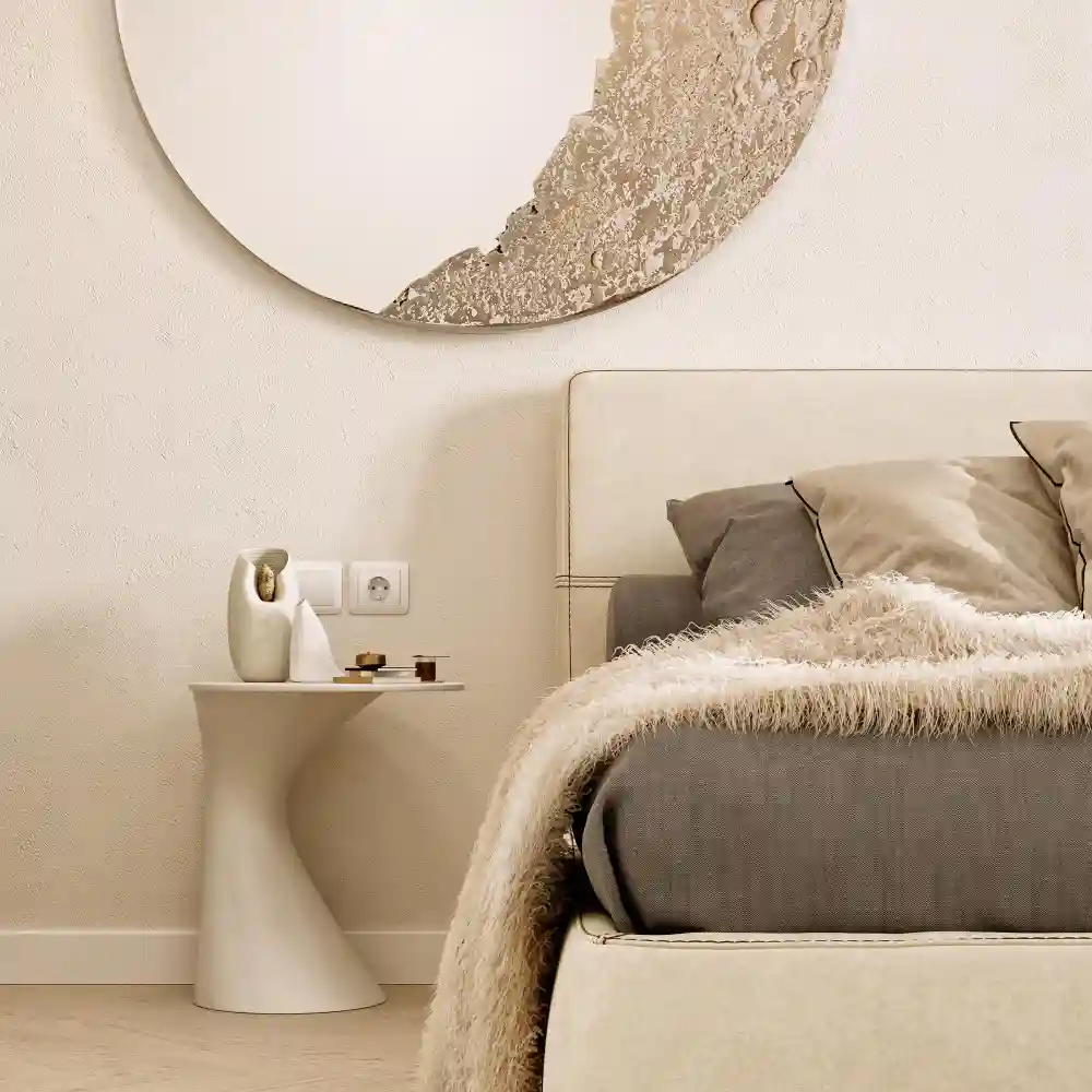 Soft limewash textured walls in warm greige behind a low bed in a minimal japandi bedroom