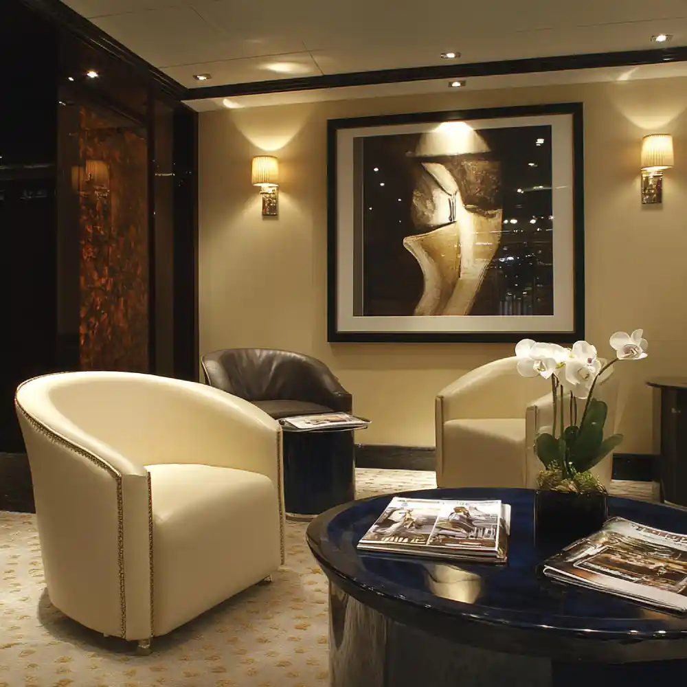 Living room lighting ideas using brushed brass plug-in wall sconces beside a console table to fill a dark corner