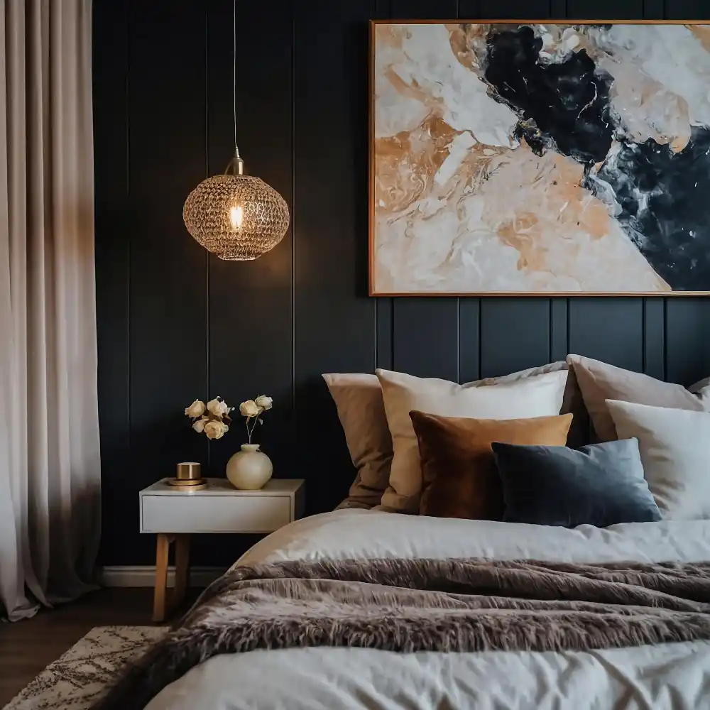 Charcoal bedroom with a low walnut platform bed, cream wool bedding, and two warm nightstand lamps