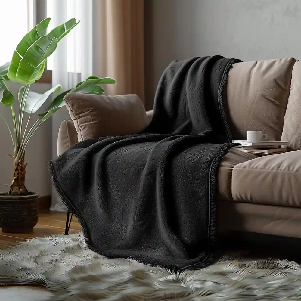 Masculine bedroom texture layering with chunky wool throw, leather bench, raw oak nightstand, matte black lamp
