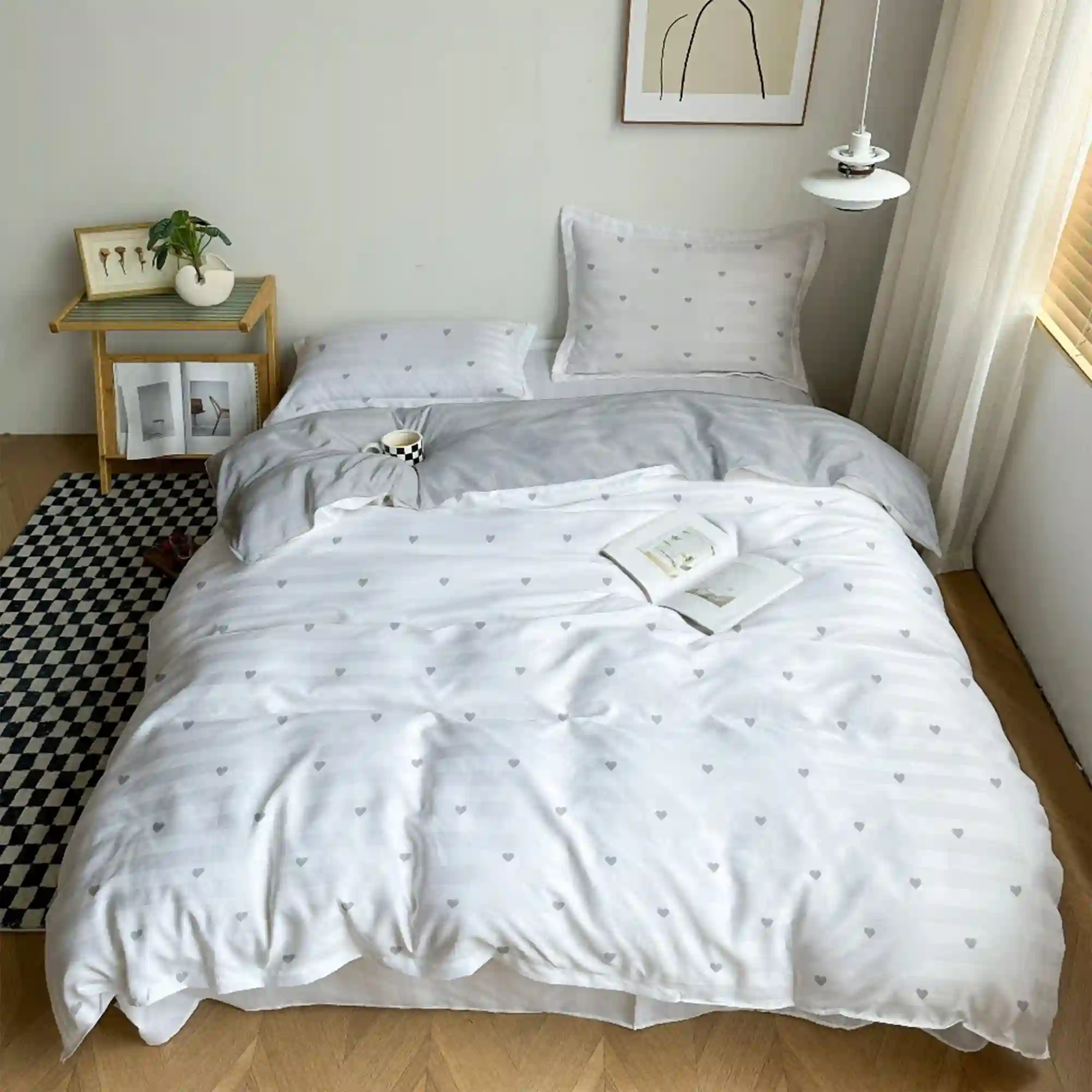 Budget-friendly microfiber Twin XL bedding set in soft grey and white on a college dorm bed