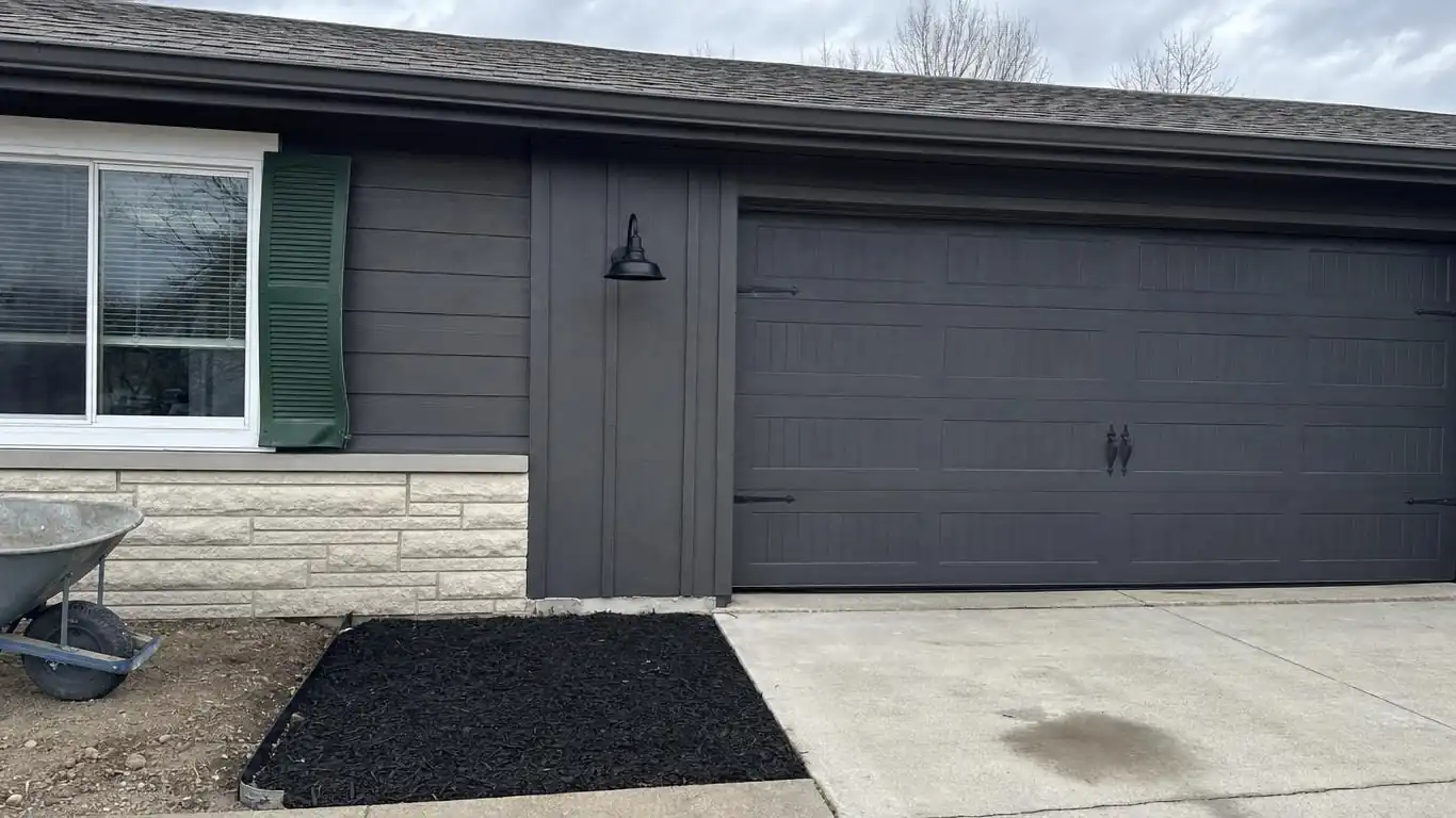 Ranch exterior with removed arborvitae and updated trim showing contrast of dated versus refreshed styling