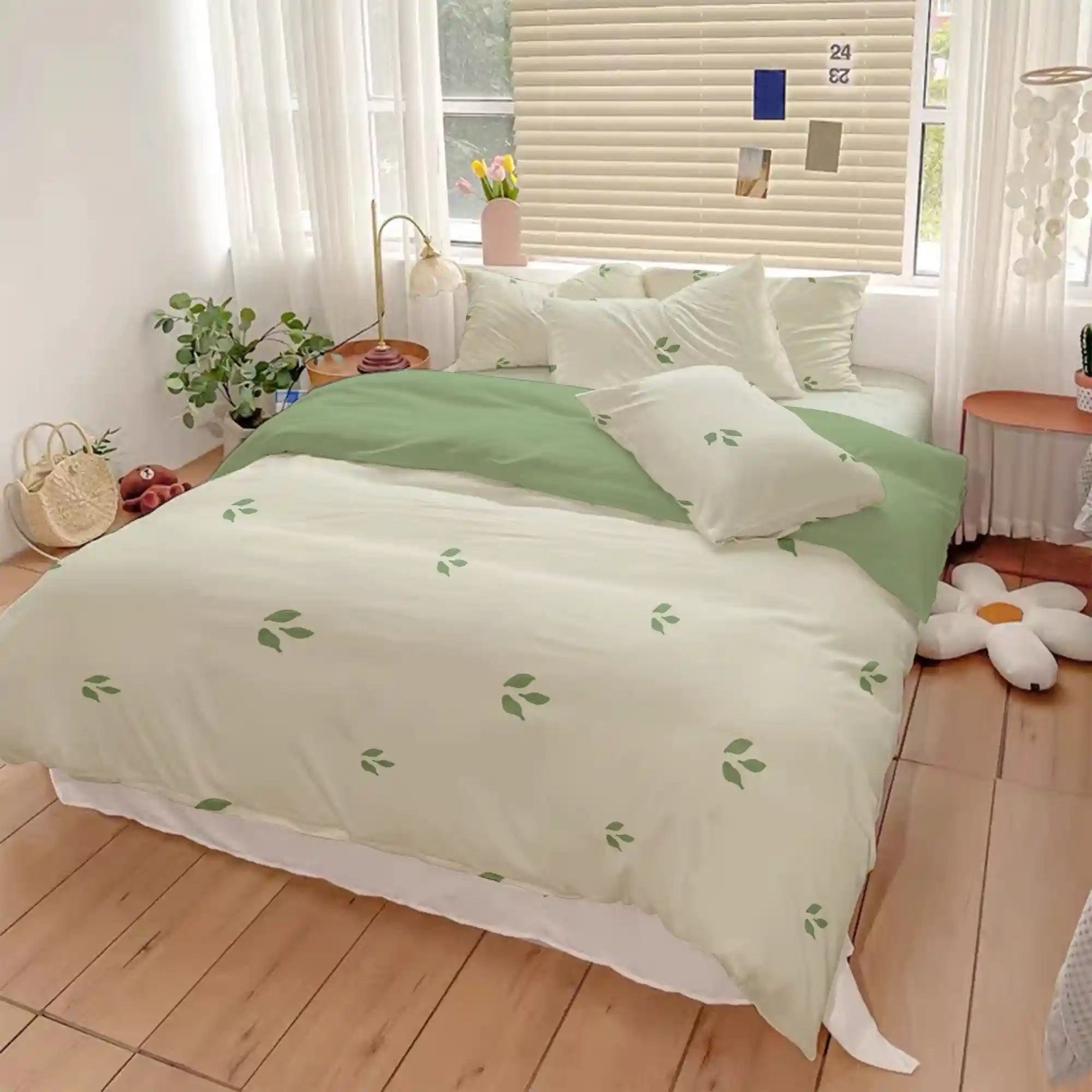 Sage green linen-look duvet cover on a Twin XL dorm bed with warm cream pillowcases and a natural cotton throw