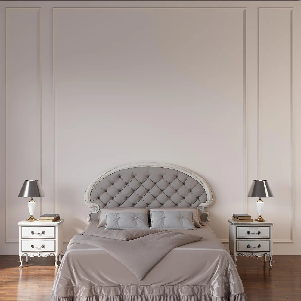 Bright small bedroom with warm white walls, cream linen headboard, jute rug, and brass lamp