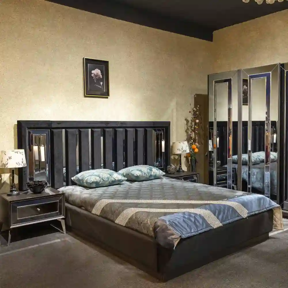 Two warm 2700K bedside lamps and a floor lamp glowing low in a master bedroom on a dimmer at night