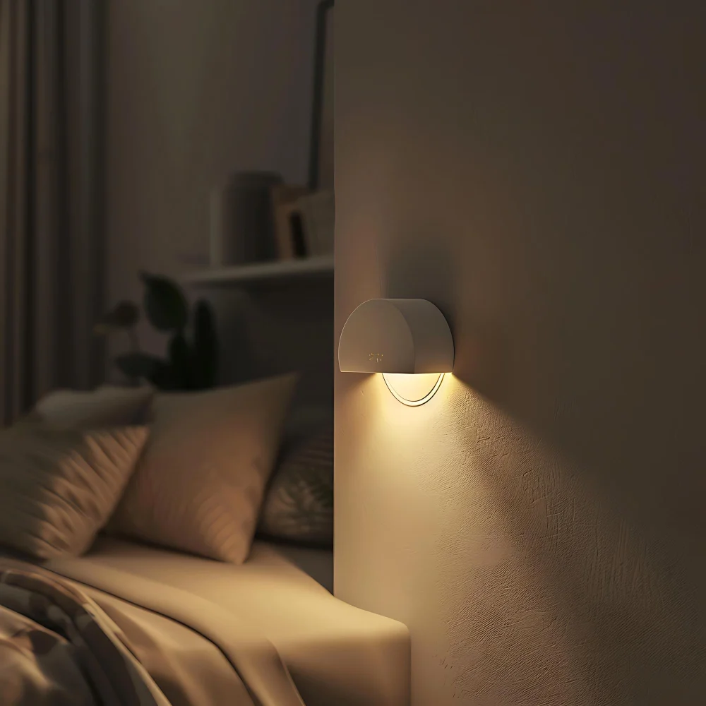 Warm 2700K light bulb glowing golden in a bedroom lamp next to neutral linen bedding