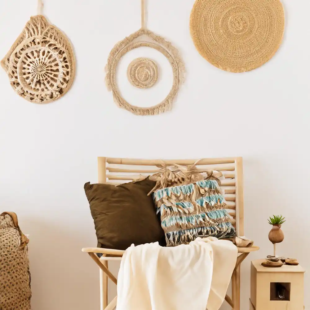 Warm boho teen bedroom with a low rattan bed frame, terracotta palette, chunky knit throw, and a woven wall hanging