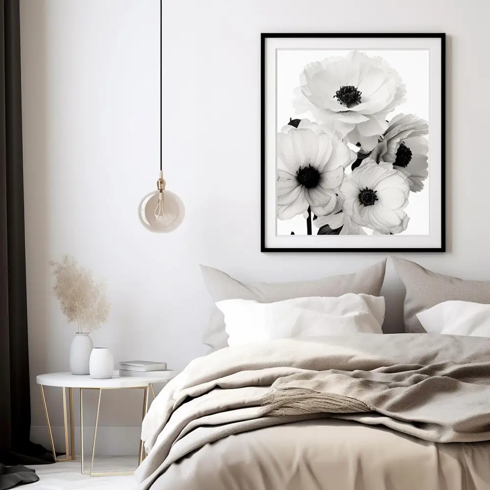 White bedroom with a single matte black lamp and framed print adding quiet contrast