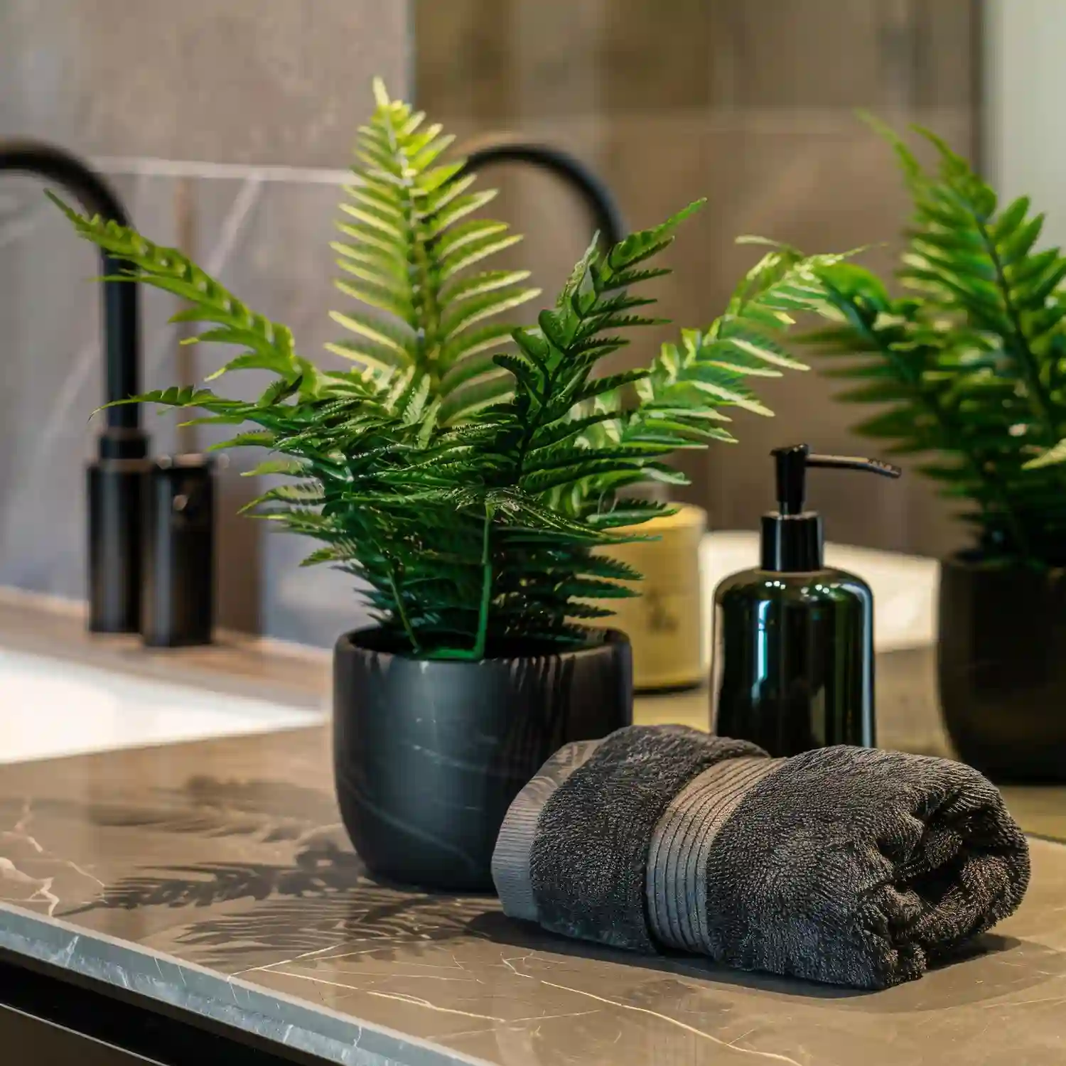 Floating shelf above a bathroom vanity holding trailing pothos and a small potted fern