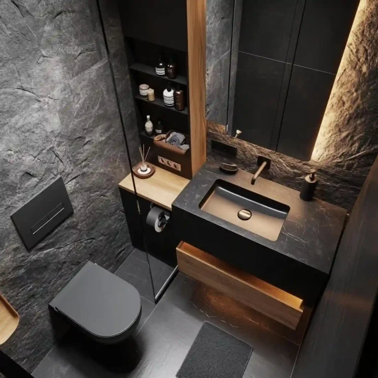 Dark stone powder room seen from above with a wood floating vanity, black basin, wall-hung black toilet and a black toilet paper holder