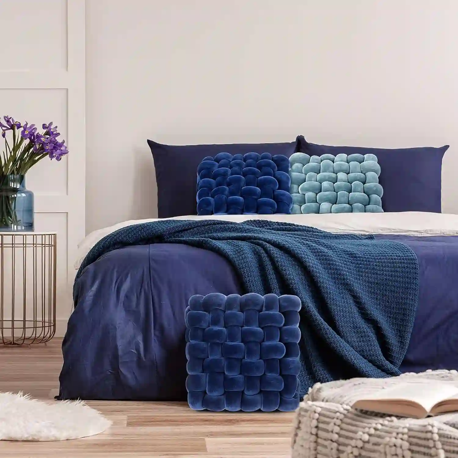 Dusty blue linen duvet cover with cream Euro shams on a styled bed, jute rug and warm 2700K lamp nearby