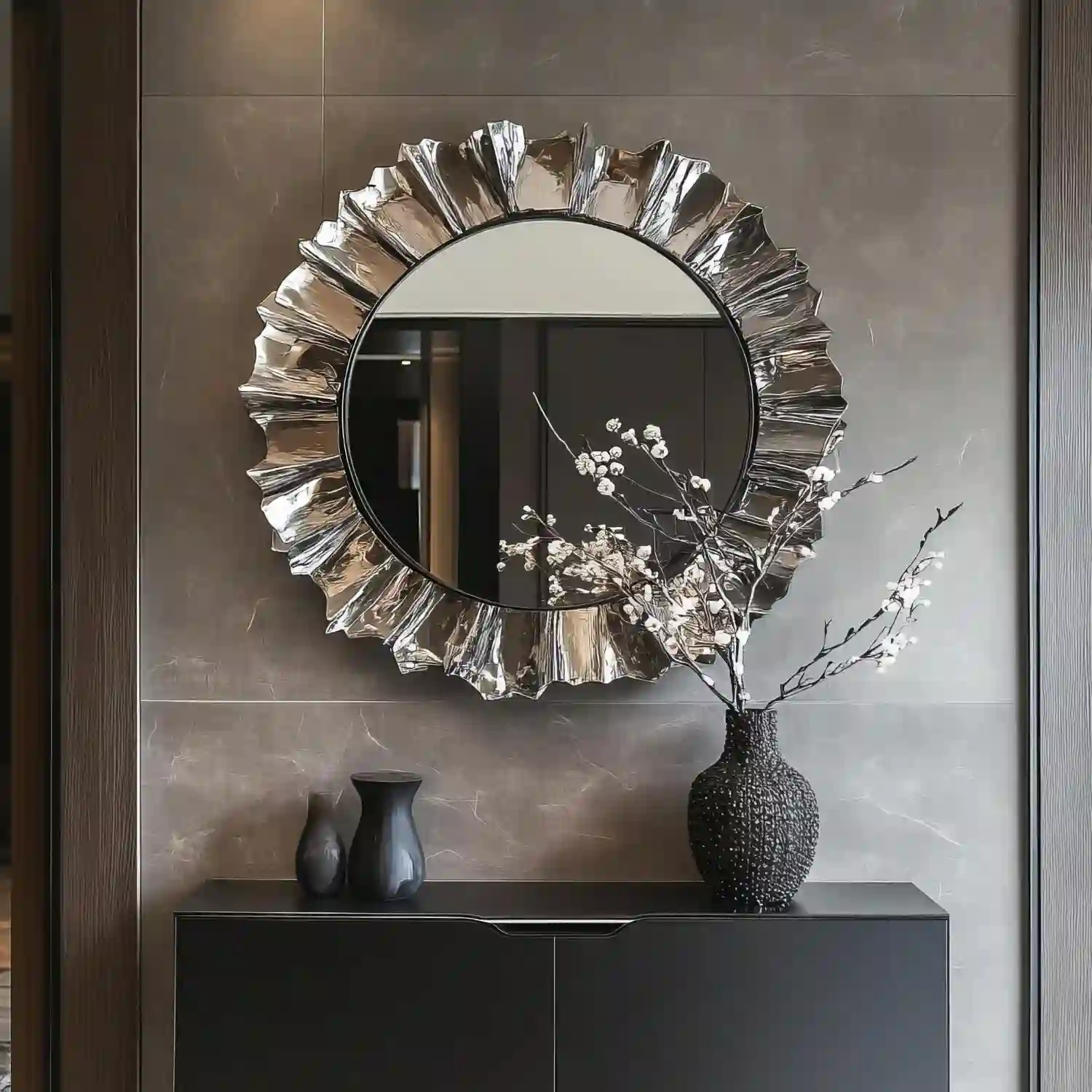 A thin eucalyptus garland draped along the top of a bathroom mirror in a warm neutral room