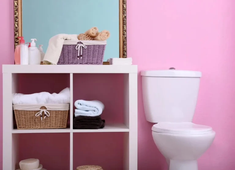 Small bathroom with a warm oak wall-mounted cabinet and floating shelves above a white toilet tank