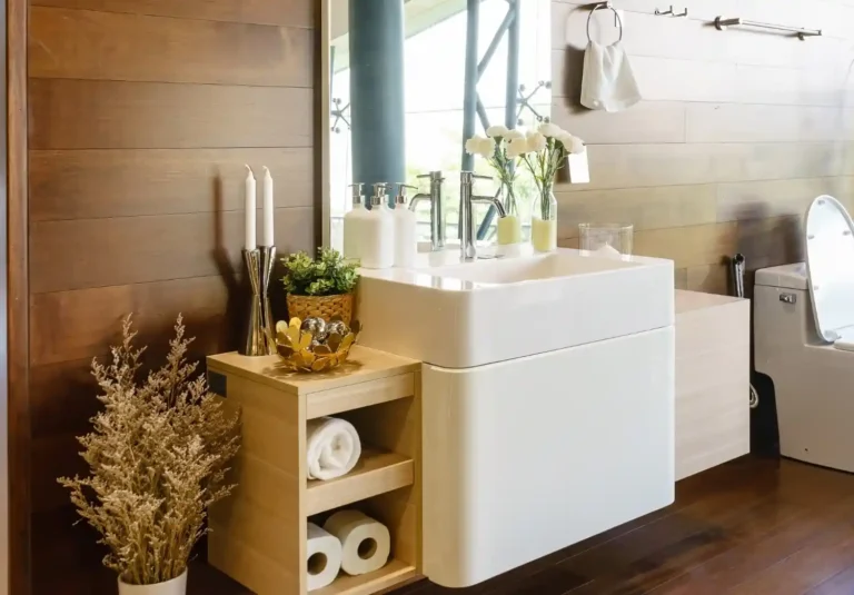 Small bathroom organized with over-the-toilet shelving, floating shelves, and labeled storage bins