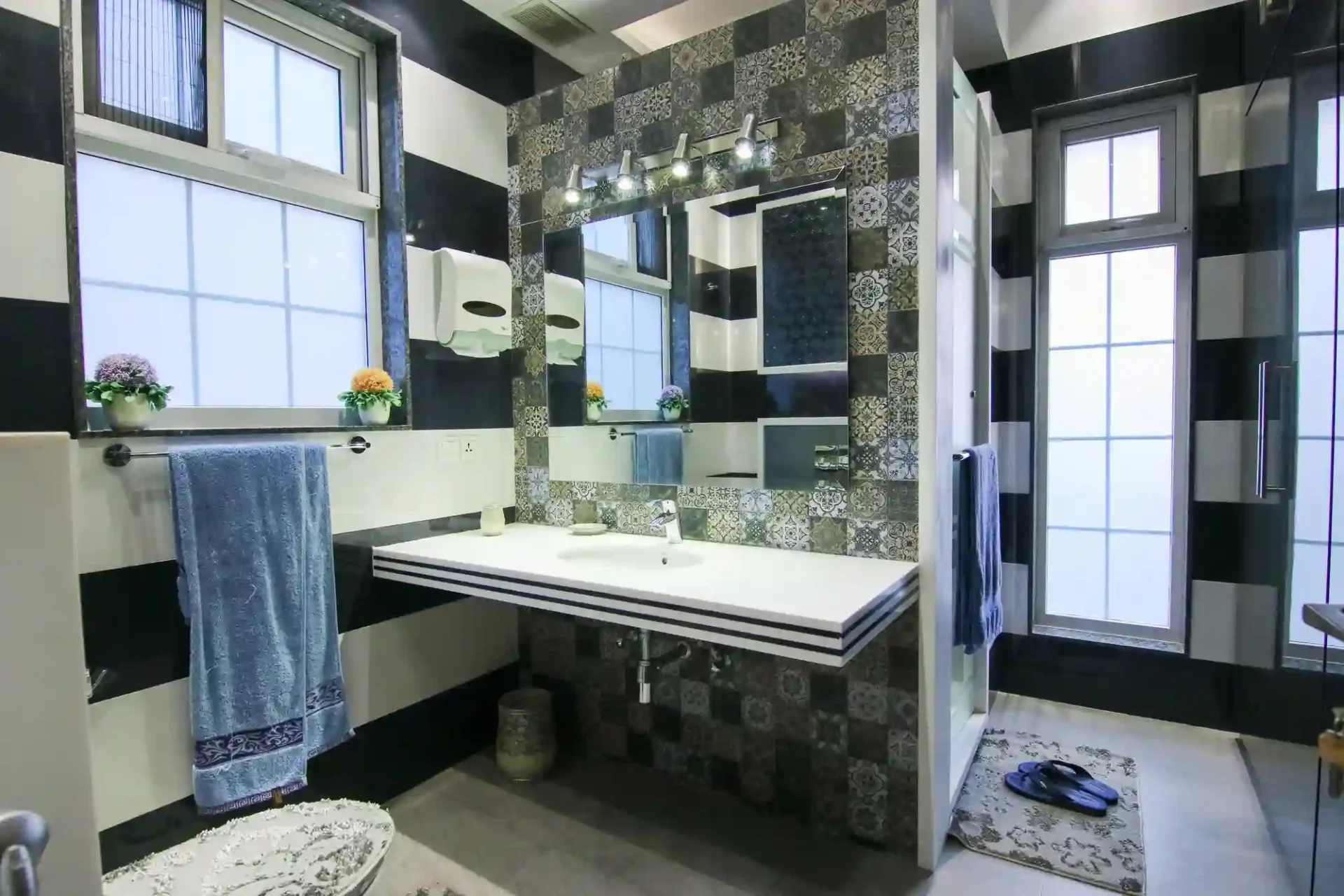 Tiny under-stairs half bathroom with sloped ceiling, light walls, and a compact 24-inch pedestal sink