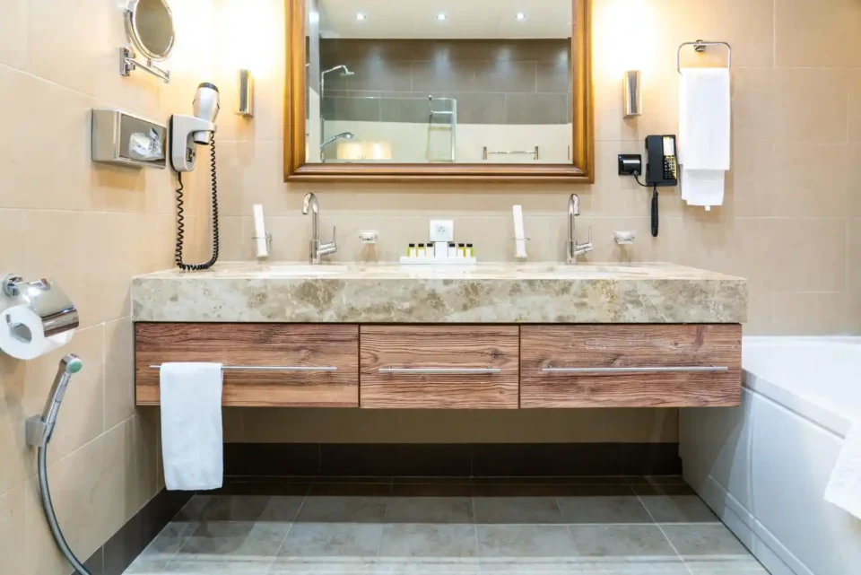Neat bathroom vanity cabinet with two-tier shelf, clear labeled bins, and a turntable around the drainpipe
