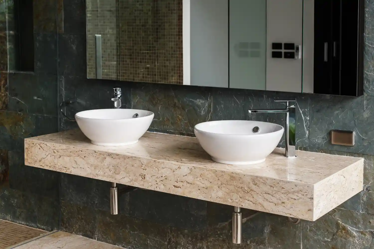 Warm fireclay vessel bowl sitting on a lowered wood vanity in a powder room with a tall single-hole faucet