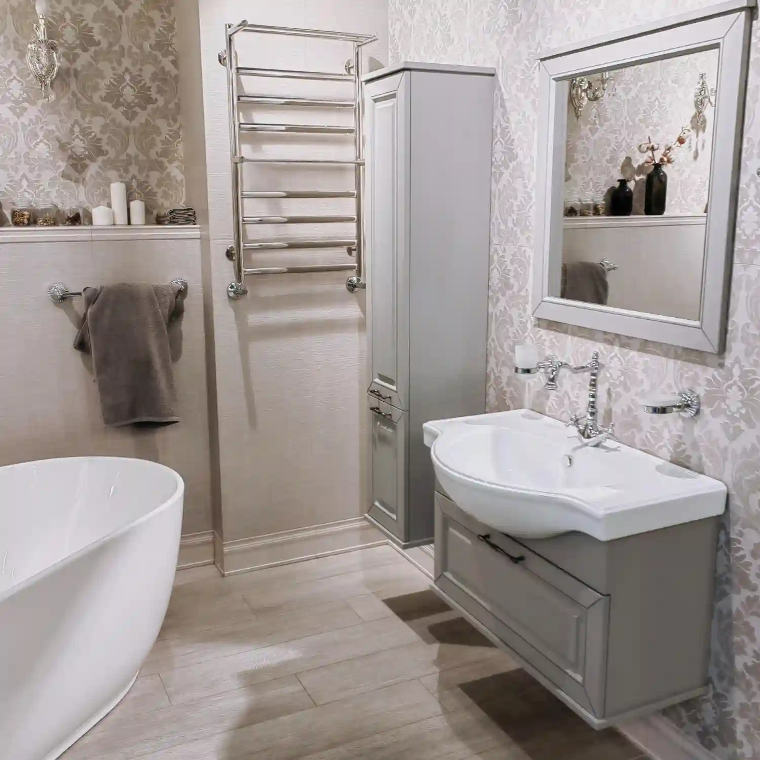 White bathroom with brushed brass faucet, towel bar, and cabinet pulls against warm white
